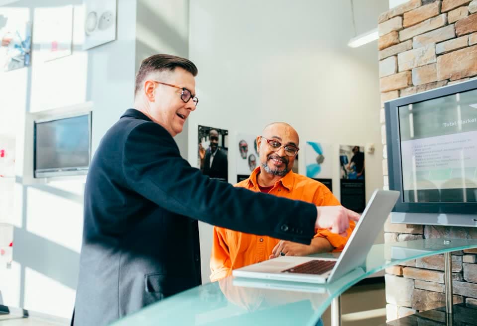 Two colleagues shaking hands in an office