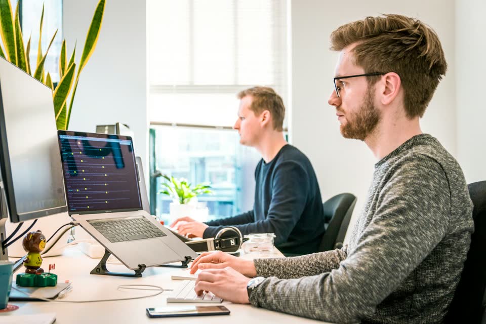 Two engineers at their screens